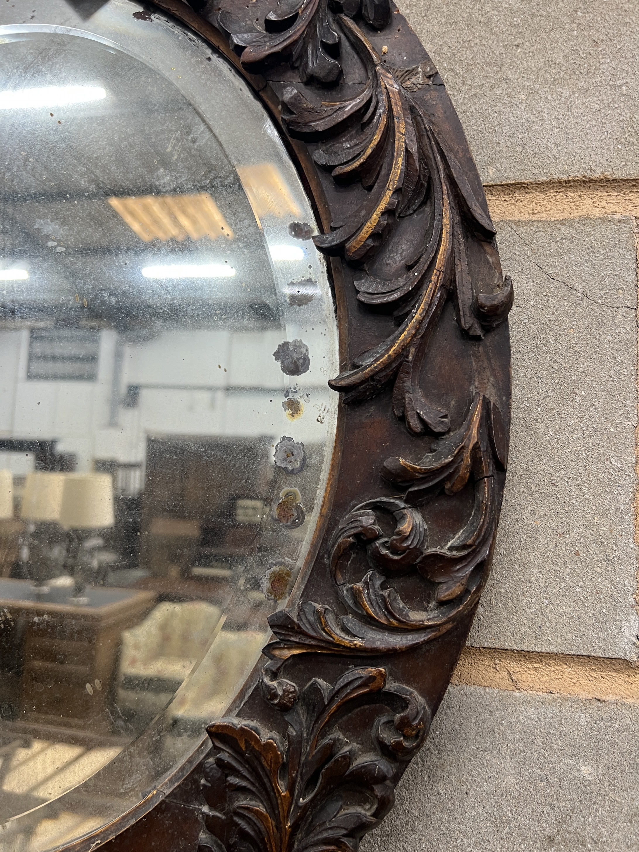 An 18th century style carved wood oval wall mirror, width 57cm, height 67cm
